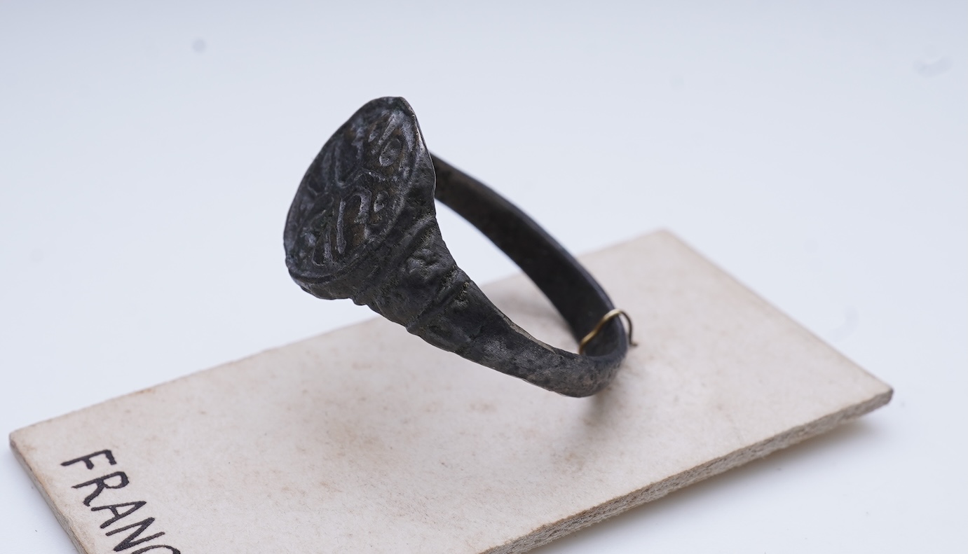 A sentimental signet ring, France, circa 16th century, the circular panel depicting two hearts tied in a true lover's knot, size R1/2, labelled 2244, Provenance: formerly in the collection of Dame Joan Evans (1893-1977)